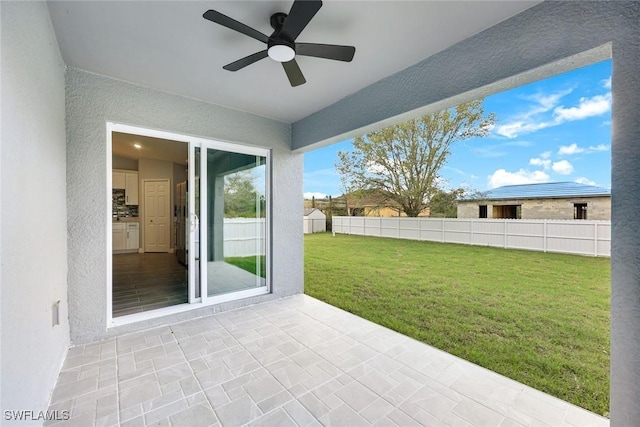 view of patio / terrace featuring fence and ceiling fan