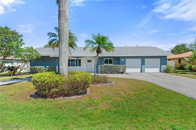 ranch-style house featuring a garage, concrete driveway, a front lawn, and stucco siding