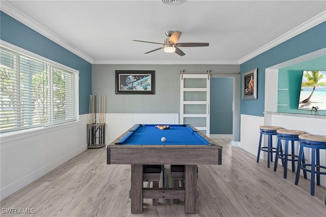 recreation room with a barn door, billiards, a ceiling fan, ornamental molding, and wood finished floors