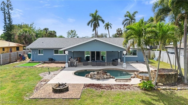 rear view of property featuring an outdoor living space with a fire pit, a fenced backyard, a yard, and a patio