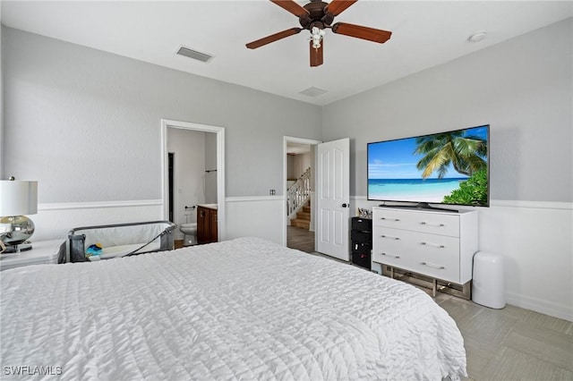 bedroom with ceiling fan, connected bathroom, and visible vents