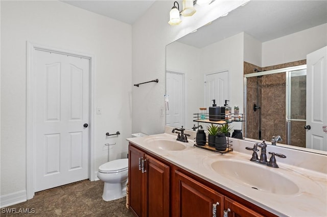 full bath featuring a stall shower, a sink, toilet, and double vanity