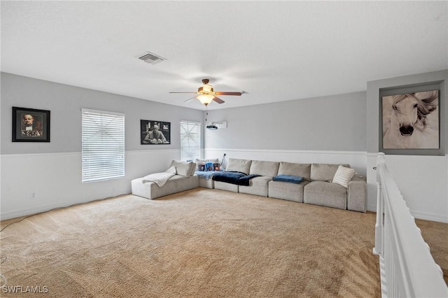 carpeted living room featuring visible vents and ceiling fan