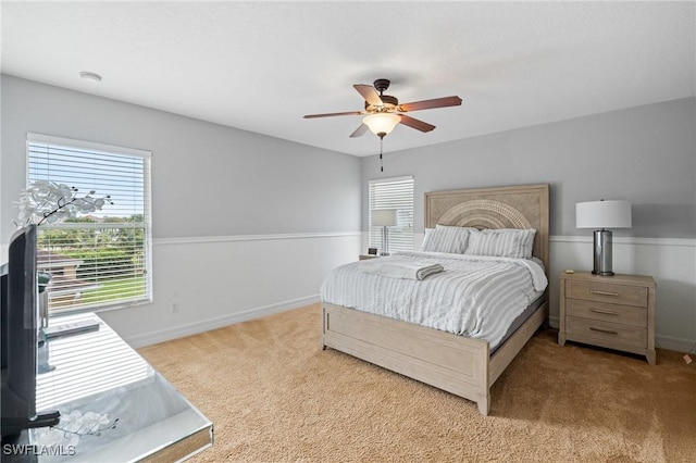 carpeted bedroom featuring a ceiling fan and baseboards