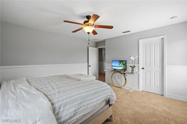 carpeted bedroom featuring visible vents, ceiling fan, and baseboards