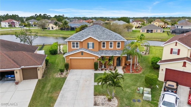 birds eye view of property with a residential view and a water view