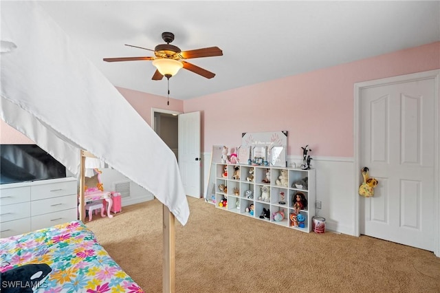 carpeted bedroom with a ceiling fan and visible vents