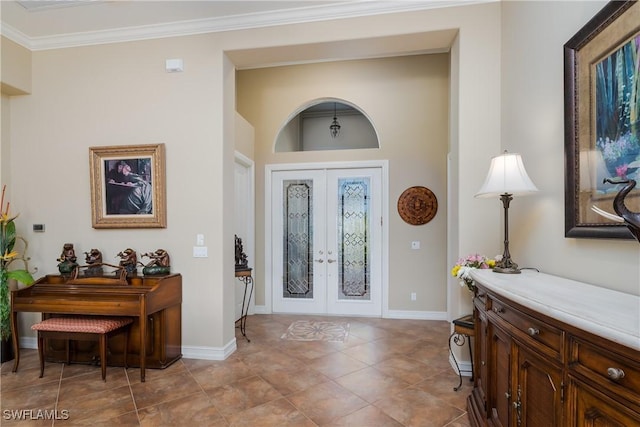 entrance foyer featuring baseboards, french doors, and crown molding