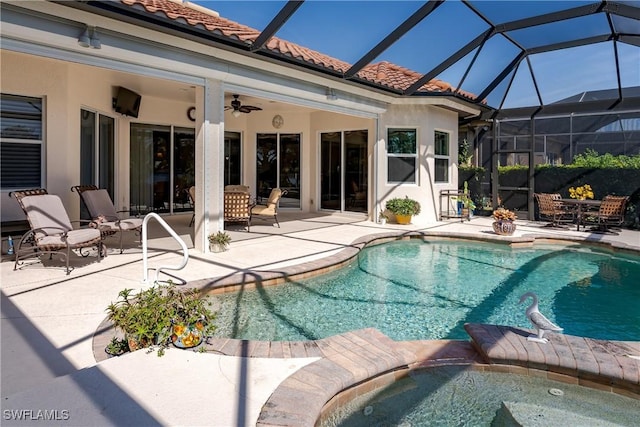 view of pool with a ceiling fan, a pool with connected hot tub, and a patio