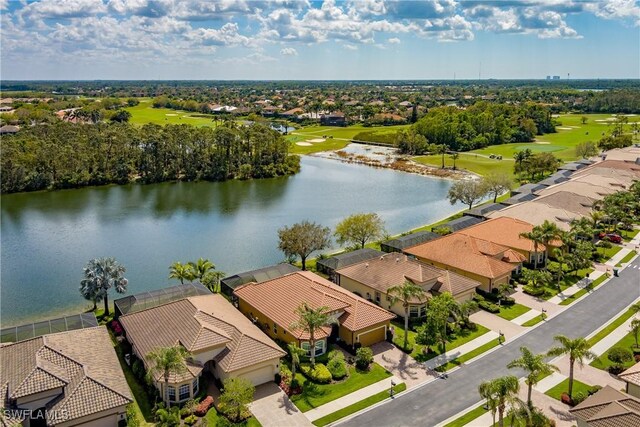 aerial view with view of golf course, a water view, and a residential view