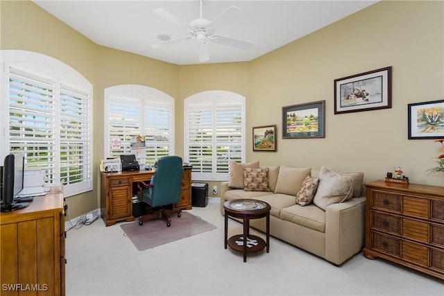 home office featuring carpet, baseboards, and a ceiling fan