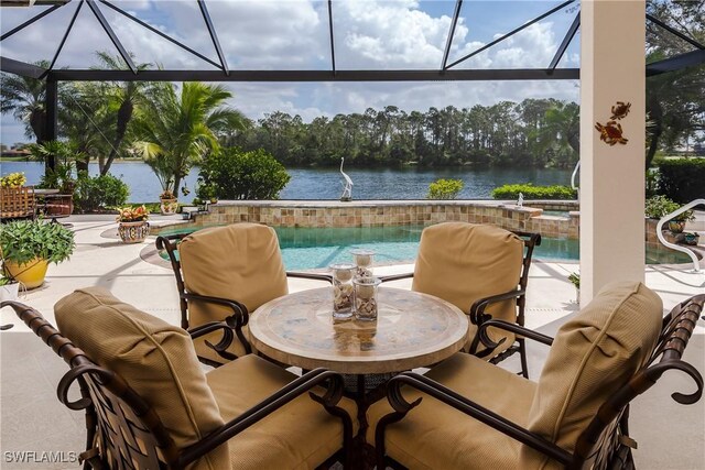 view of patio / terrace with glass enclosure, a water view, and a pool with connected hot tub