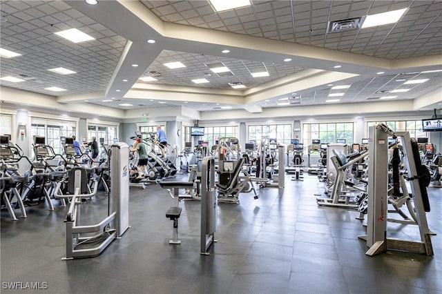 workout area featuring visible vents, a raised ceiling, and a drop ceiling