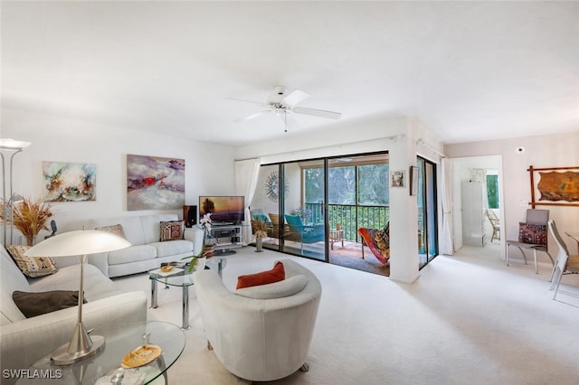 living room with ceiling fan and carpet flooring