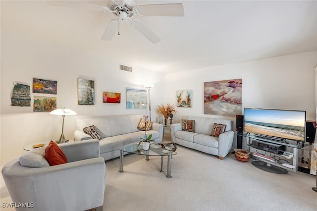 living area featuring carpet floors, visible vents, and a ceiling fan