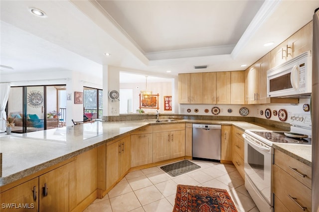 kitchen with white appliances, light stone counters, a tray ceiling, light brown cabinetry, and light tile patterned flooring