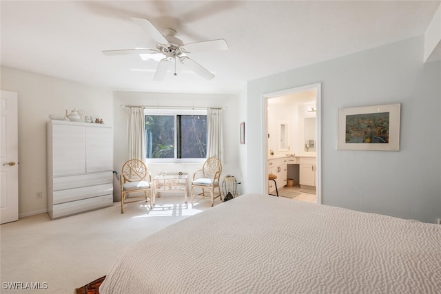 bedroom featuring a ceiling fan, light carpet, and connected bathroom