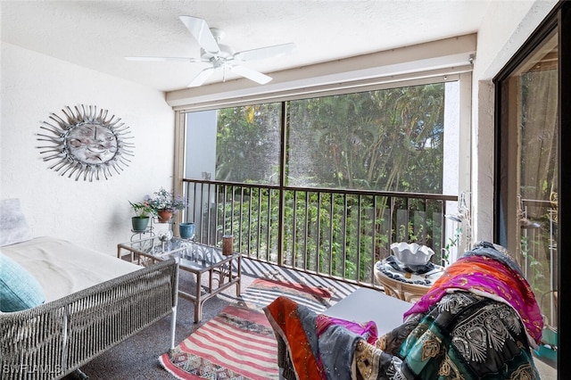 sunroom featuring a ceiling fan