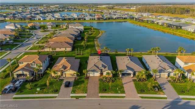 drone / aerial view with a water view and a residential view