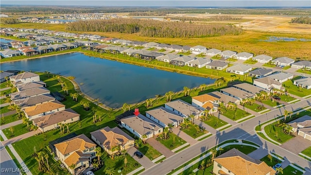 drone / aerial view with a residential view and a water view