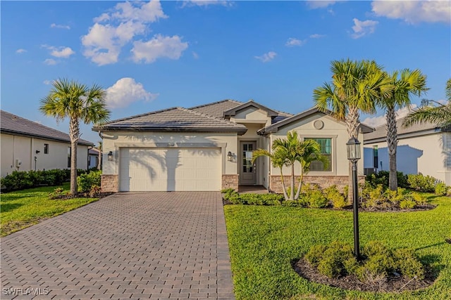 view of front facade featuring an attached garage, stone siding, a front lawn, and decorative driveway