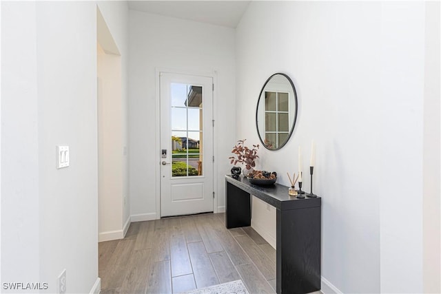 entryway featuring light wood-type flooring and baseboards