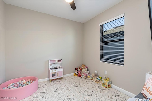 rec room featuring carpet floors, ceiling fan, and baseboards