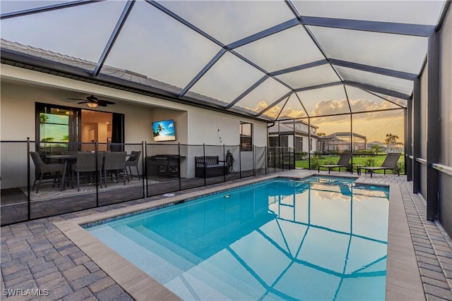 view of pool featuring a pool with connected hot tub, a lanai, and a patio