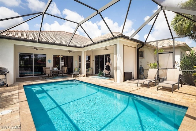 pool with ceiling fan, a patio, and a lanai