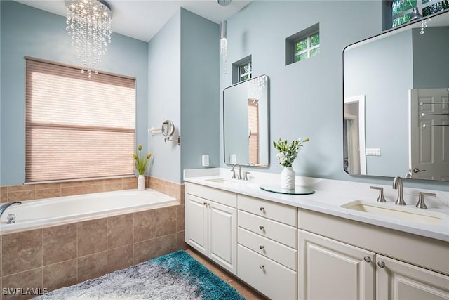 bathroom featuring a garden tub, a sink, and double vanity