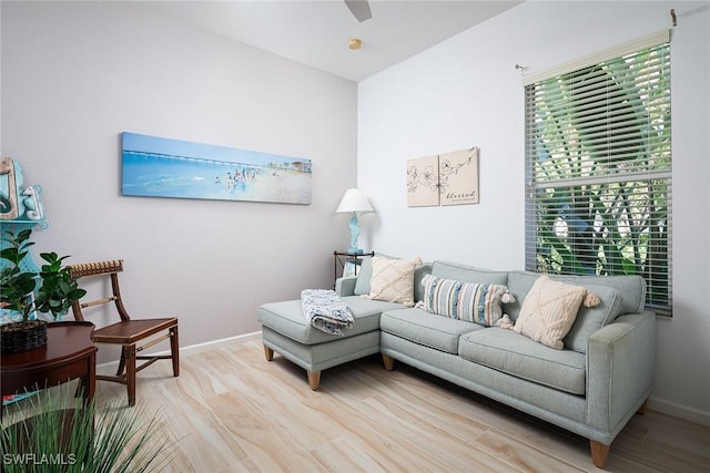 living area with light wood-style floors and baseboards