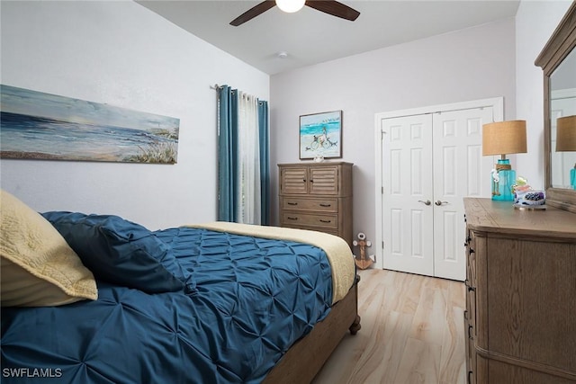 bedroom featuring light wood-type flooring, a closet, and ceiling fan