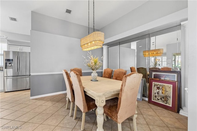 dining space with a wealth of natural light, visible vents, and light tile patterned flooring