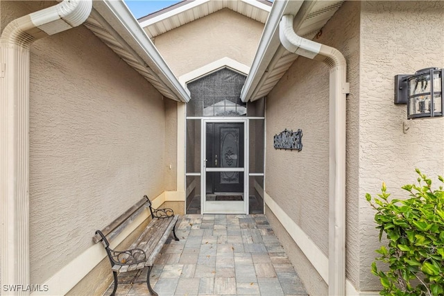 property entrance with stucco siding