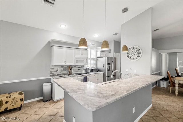 kitchen featuring white appliances, visible vents, decorative backsplash, and white cabinets