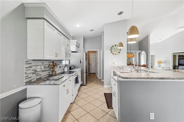 kitchen with light tile patterned floors, lofted ceiling, backsplash, white cabinetry, and white appliances