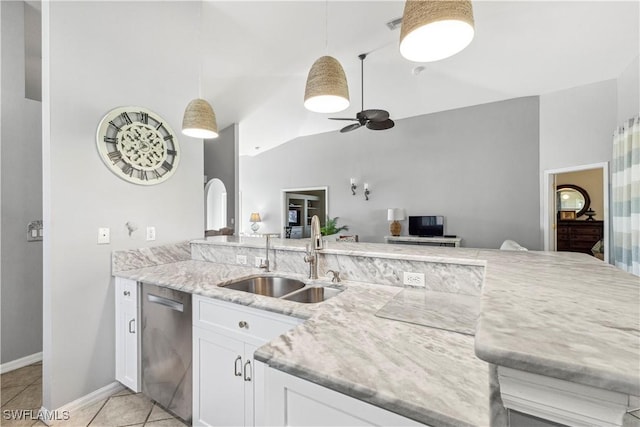 kitchen with light tile patterned floors, a sink, a ceiling fan, stainless steel dishwasher, and light stone countertops