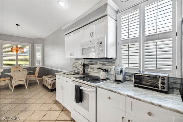 kitchen with pendant lighting, a toaster, white cabinets, light tile patterned flooring, and white appliances