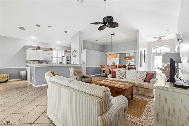 living room featuring visible vents, baseboards, ceiling fan, light tile patterned flooring, and recessed lighting