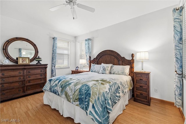 bedroom featuring ceiling fan, baseboards, and wood finished floors