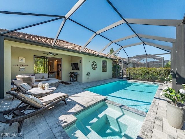 view of pool with an outdoor hangout area, a pool with connected hot tub, a ceiling fan, grilling area, and a patio area