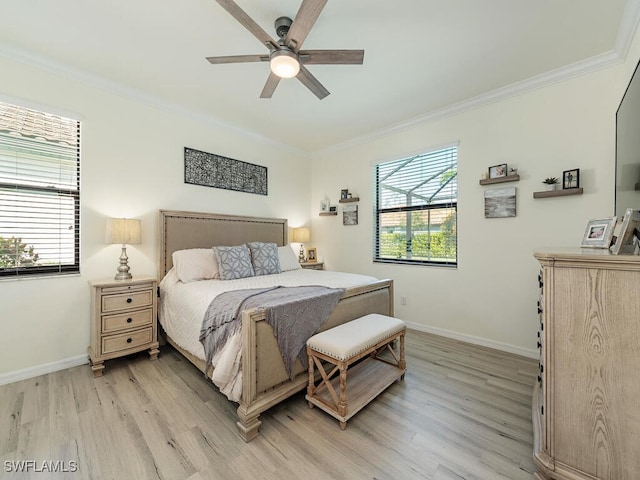 bedroom with light wood finished floors, ornamental molding, multiple windows, and baseboards