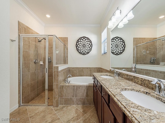 bathroom with a shower stall, ornamental molding, and a sink