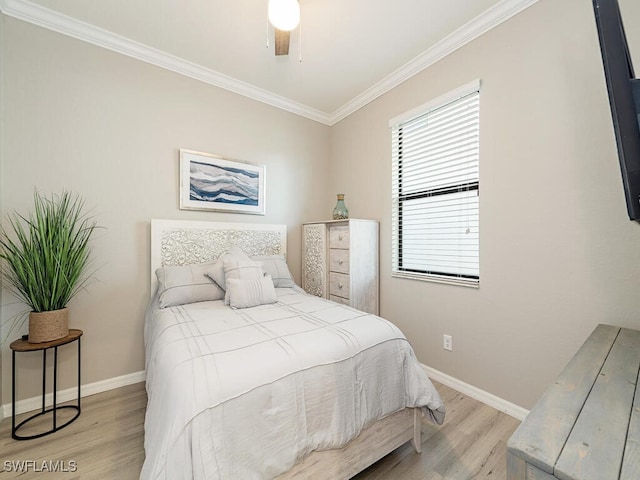 bedroom with ceiling fan, ornamental molding, light wood-type flooring, and baseboards