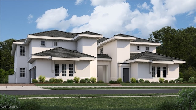 view of front of property featuring a tiled roof and stucco siding