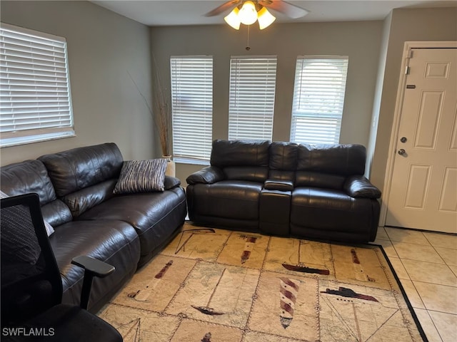 living area with a ceiling fan and light tile patterned floors