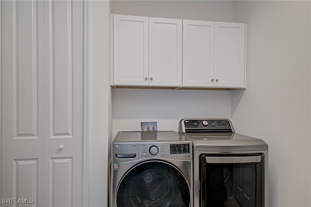 laundry room with cabinet space and washer and dryer