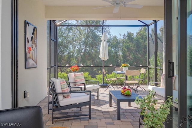 sunroom / solarium featuring ceiling fan