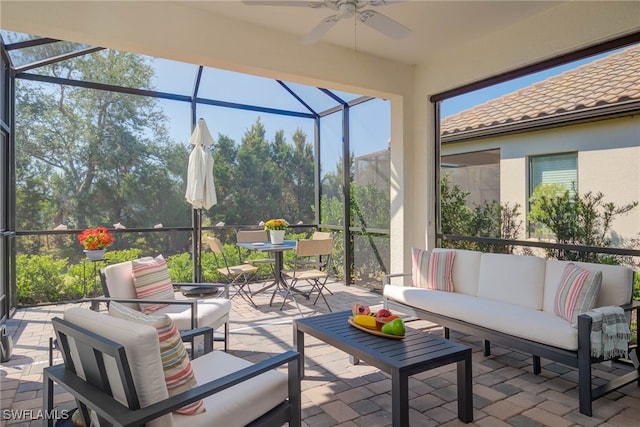 view of patio / terrace with glass enclosure, outdoor lounge area, and a ceiling fan