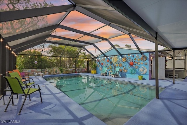 outdoor pool with a patio and glass enclosure